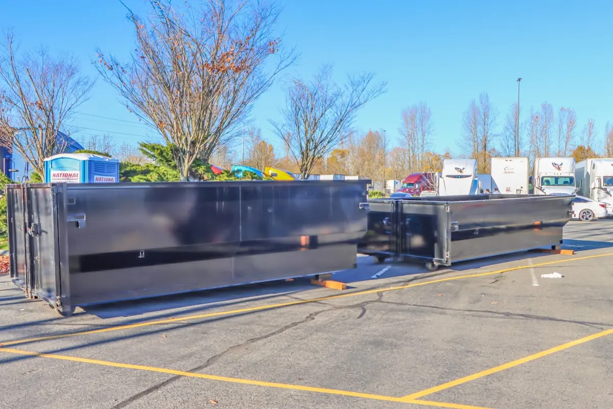 Professional dumpster rental service with roll-off container on residential driveway in Monahans